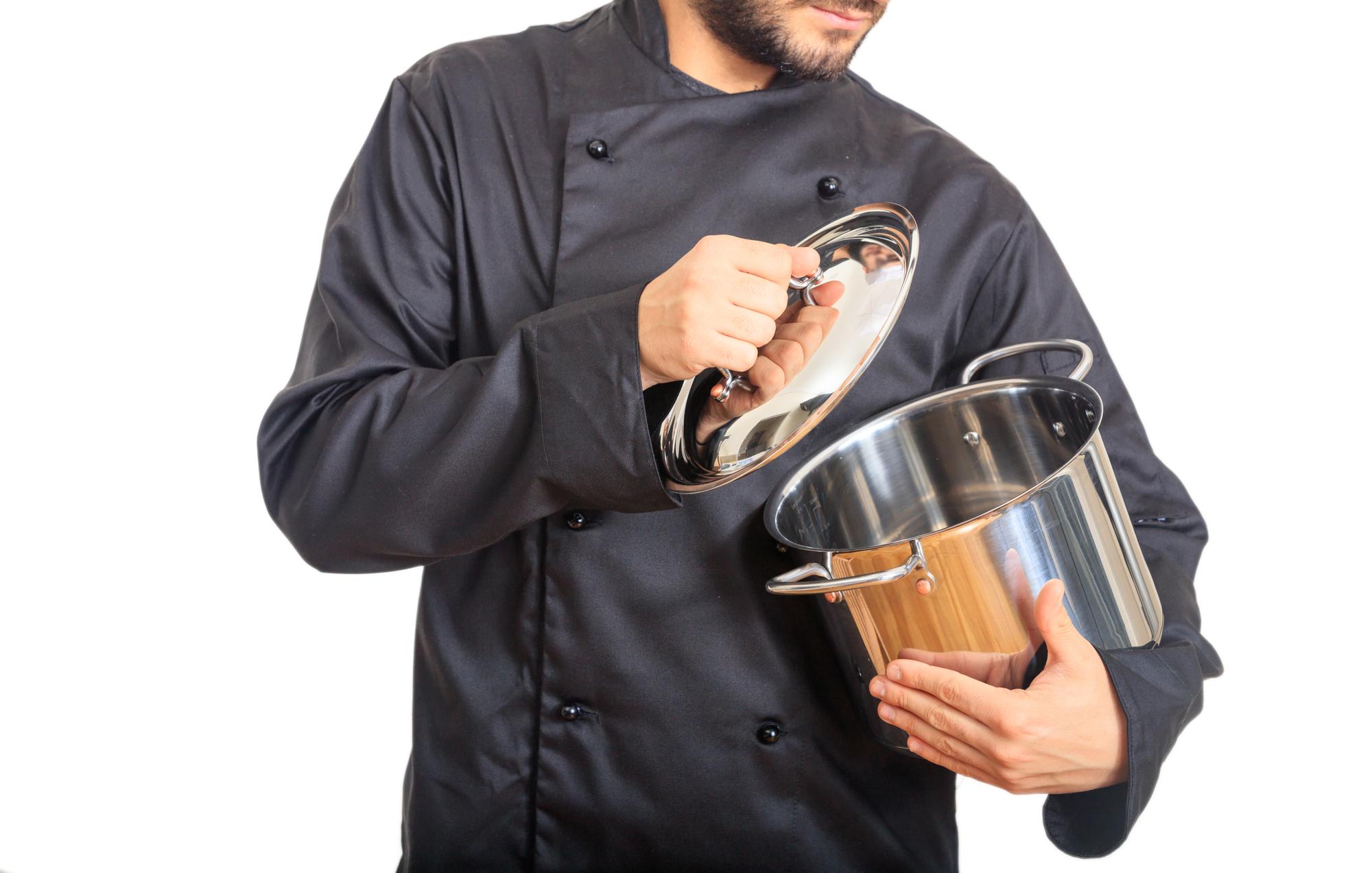 Chefs prepping ingredients on a stainless counter